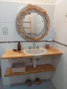 a bathroom with a sink and a mirror at Casa Inkill Huasi in Tilcara +14 photos