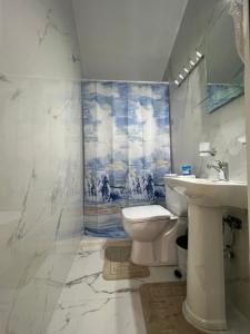 a bathroom with a toilet and a sink at LakeFront House in Shirokë +48 photos