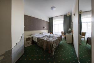Postel nebo postele na pokoji v ubytování Hotel St. Barbara