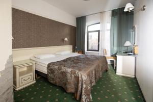 Postel nebo postele na pokoji v ubytování Hotel St. Barbara