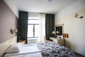 Postel nebo postele na pokoji v ubytování Hotel St. Barbara