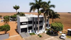 an aerial view of a building with palm trees at Hotel Home in Lucas do Rio Verde