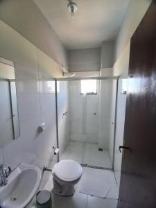 a bathroom with a shower and a toilet and a sink at Hotel Home in Lucas do Rio Verde