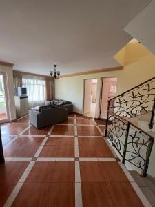 a large living room with a couch and a floor at Casa con Piscina en Cochabamba in Cochabamba