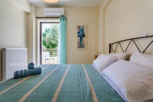 A bed or beds in a room at Armonia Studios Avia 2