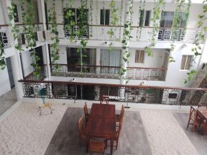 an empty courtyard of a building with a table and chairs at CASA BARKA in Playa del Carmen