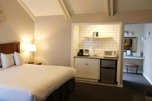 a white kitchen with a white bed and a white refrigerator at Golden Haven Hot Springs in Calistoga