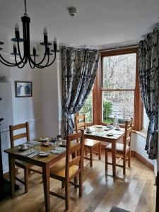 a dining room with a table and chairs and a window at Dolweunydd Bed and Breakfast in Betws-y-coed