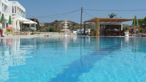 a large pool of blue water in a resort at Kokalakis Hotel in Kefalos
