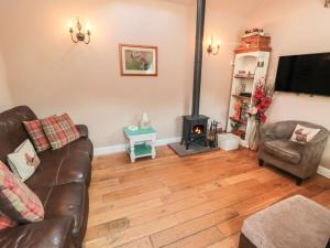 a living room with a couch and a fireplace at Norah's Nook in Gillamoor