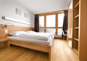 Postel nebo postele na pokoji v ubytování Hotel Manggei Designhotel Obertauern