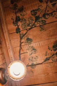 a ceiling with a painting of flowers on it at Sunny Nights Homestead Historic House in Gataučiai