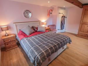 a bedroom with a bed with a teddy bear laying on it at Erica's 'eaven in Gillamoor