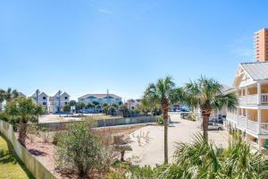 a view of a beach with palm trees and condos at Southwind I-9 in Panama City Beach
