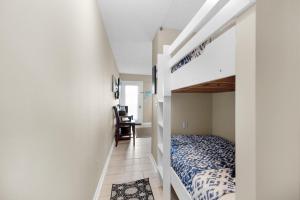 a bedroom with a bunk bed and a desk at Southwind I-9 in Panama City Beach +24 photos