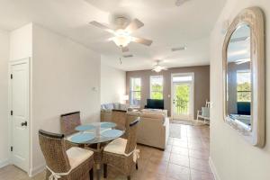 a dining room and living room with a table and chairs at Topsail Village 422 in Santa Rosa Beach