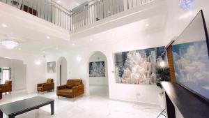 a living room with white walls and a ceiling at Royal Court Lounge & Boutique Hotel in Port Harcourt