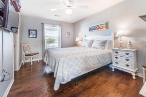a bedroom with a bed and a chair and a window at Beachside Villas 332 in Santa Rosa Beach +36 photos