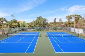 a tennis court with two tennis courts at Beachside Villas 332 in Santa Rosa Beach