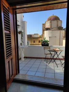 a balcony with a table and a view of a building at Da Marilù in Mazara del Vallo