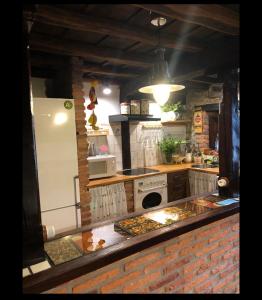 a kitchen with a stove and a refrigerator at La Saleta in Bejes +31 photos