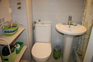 a small bathroom with a toilet and a sink at GoVienna - Charming Studio in Vienna
