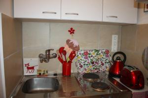 a kitchen counter top with a sink and a counter top at GoVienna - Charming Studio in Vienna