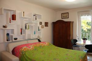 a bedroom with a bed and a wall of books at GoVienna - Charming Studio in Vienna