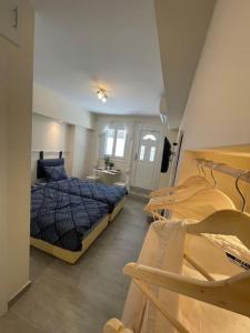 a bedroom with a bed and two chairs in it at Vatos Studio in Vátos