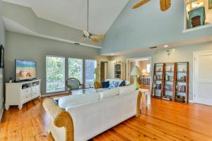 a living room with a white couch and a tv at SECRET HARBOR in Sanibel