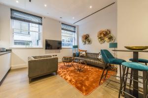 a living room with a couch and a table at Chancery Quarters - 124 Chancery Lane in London