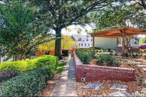 a garden with a brick wall and a gazebo at Wine Down Suite King Bd, 400mbps, Kitchen,Free Parking Pool in Atlanta