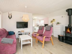 een woonkamer met een bank, 2 stoelen en een open haard bij Holiday home Vinderup XXIII in Vinderup