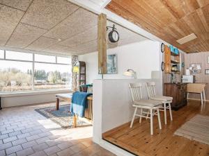 a kitchen and living room with a table and chairs at 6 person holiday home in Farsø-By Traum in Farsø