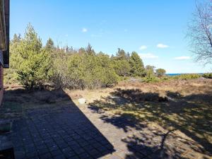 a shadow of a house on a field with trees at 8 person holiday home in Thyholm in Thyholm