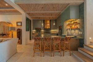 una cucina con tavolo e alcune sedie di One-of-a-kind villa with open spaces and amazing views in luxury beach resort a Punta Cana