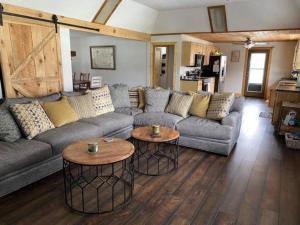 a living room with a couch and two tables at Mountain Creek Lodge in Maggie Valley