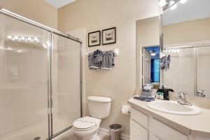 a bathroom with a toilet and a sink and a shower at Magical Adventure Condo w Waterpark near Disney No Resort Fees in Orlando