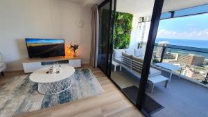 a living room with a view of the ocean at OceanView Oasis 2BR Apt - 5Mins to Beach - Family Resort in Gold Coast