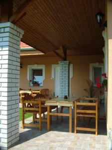 a patio with a table and chairs on a house at Horváthapartman in Bük