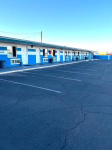 a parking lot with a blue and white building at Walden Motel in Las Vegas