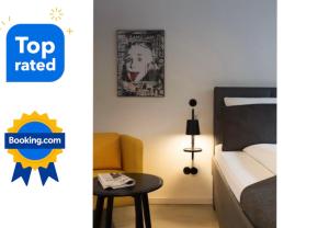 a small bedroom with a bed and a table at Square Rooms 8 in Düsseldorf