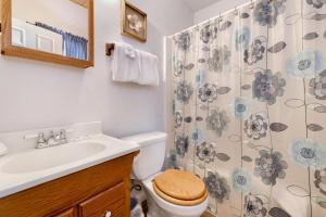 a bathroom with a sink and a toilet and a shower curtain at Whiskey Mountain Lodge #2028 by Big Bear Vacations in Sugarloaf +14 photos