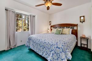 a bedroom with a bed and a ceiling fan at Whiskey Mountain Lodge #2028 by Big Bear Vacations in Sugarloaf