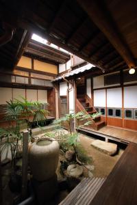 a building with a courtyard with plants in it at HEM'S HOTEL 1日1組限定 new in Miyajima