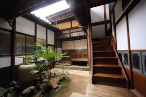 a room with a stairway leading to a building at HEM'S HOTEL 1日1組限定 new in Miyajima