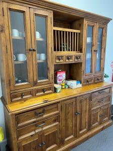 a large wooden hutch with glass doors at Oriental Hotel Tumut in Tumut