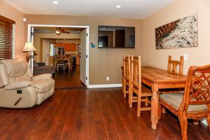 a living room with a wooden table and a dining room at Fawnskin Chalet-1826 by Big Bear Vacations in Fawnskin
