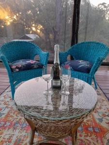 una mesa con dos copas y una botella de vino en Warren Retreat - cozy and tranquil 2 brm home, en Nannup
