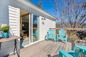 a deck with blue chairs and a grill at *NEW! The Rectory, King Bed, Home Theater, Deck, BBQ, Fire Pit in Marshall